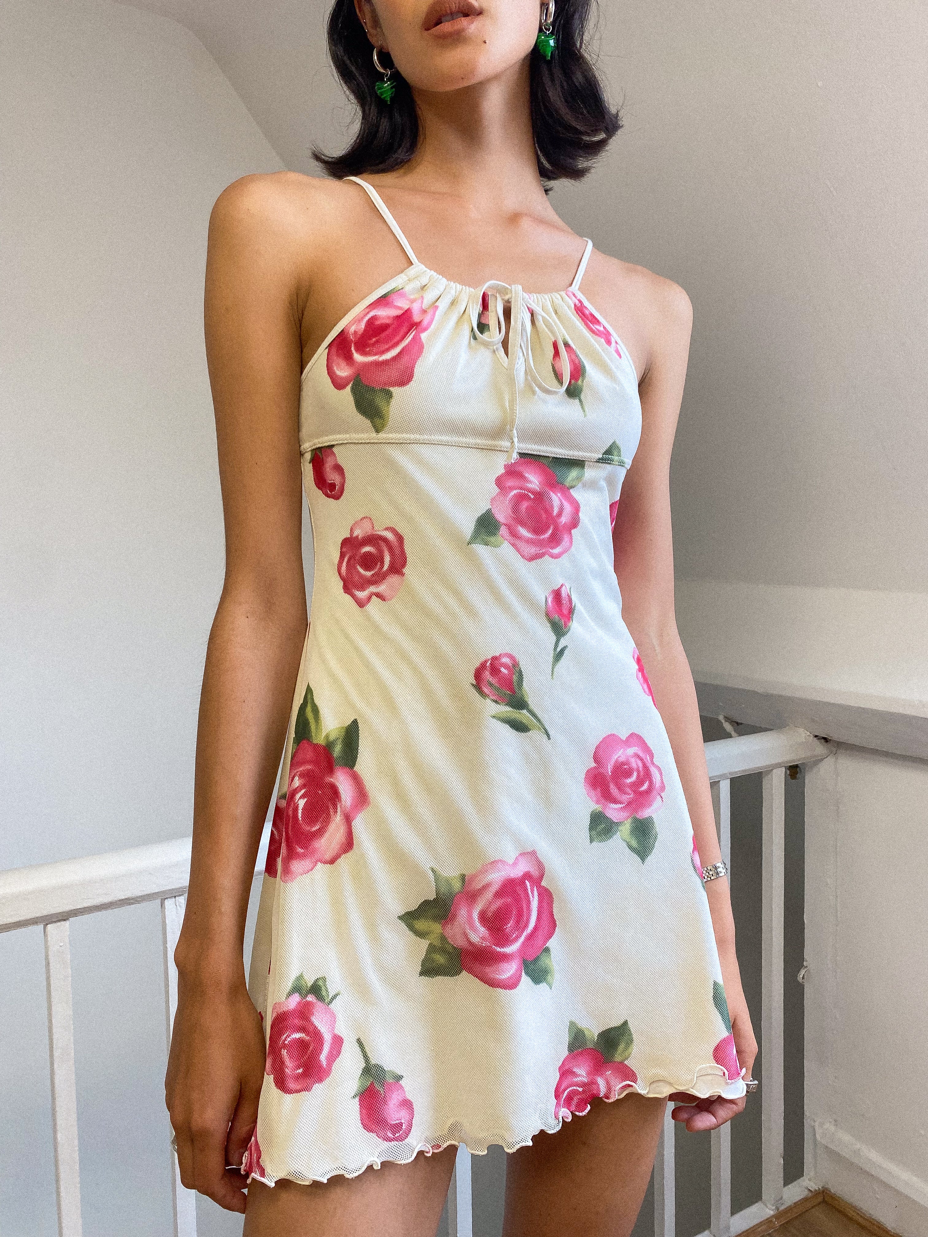 Floral dress from Miss Blumarine with large rose print on mesh fabric. Lined with stretch cotton. Aline shape, unique adjustable strap that ties at bust to effect length of straps.
